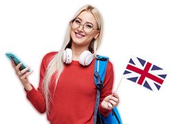 Online Education, foreign language translator, english, student - smiling blond woman in headphones holding mobile phone and British flag. Grey background, Distance learning